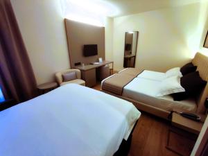 Postel nebo postele na pokoji v ubytování Vittoria Parc Hotel