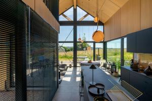 an open kitchen with a large glass wall at Arduenna Silva ecologic designer house in La-Roche-en-Ardenne