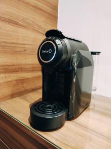 a black coffee maker sitting on a wooden counter at Apartamento Mar & Sal in Mindelo