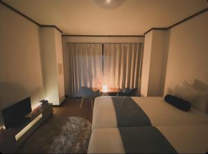 A bed or beds in a room at THE MOON Atami