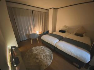 A bed or beds in a room at THE MOON Atami