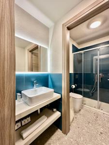 a bathroom with a sink and a glass shower at Apartments Du Parc in Sauze dʼOulx +57 photos