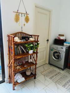 a laundry room with a washing machine and a shelf at Jamiitown Homes in Kilifi