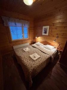 a bedroom with a bed with two towels on it at Kolazko Apartments in Vuokatti