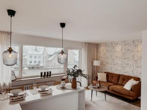 a living room with a couch and a table at Urban Suite - Detmold in Detmold