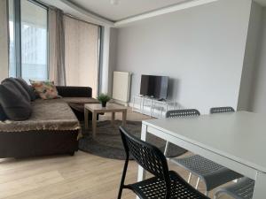 a living room with a couch and a table and chairs at Fantastic apartment two rooms in Istanbul