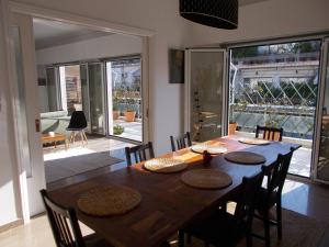 a dining room with a wooden table and chairs at Athens Ampelokipoi Penthouse in Athens