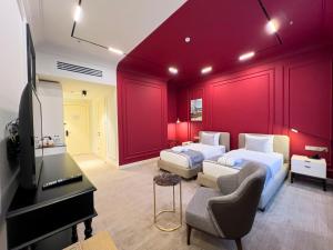 a bedroom with two beds and a flat screen tv at Bentley Hotel Tashkent in Tashkent +29 photos