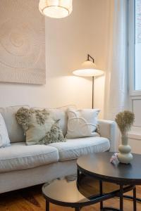 een woonkamer met een bank en een tafel bij Charming renovated and bright studio in the center in Lille