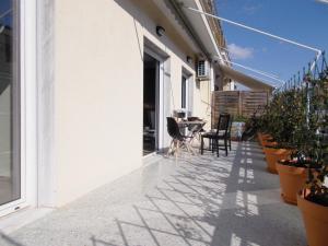 a balcony with plants and a table and chairs at Athens Ampelokipoi Penthouse in Athens