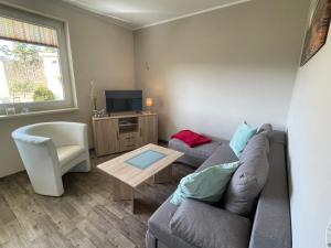 a living room with a couch and a table at Küstenbrise 1 in Graal-Müritz