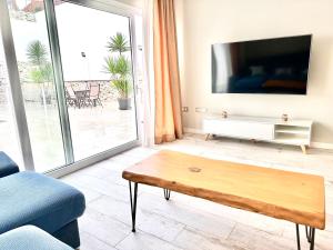 a living room with a tv and a coffee table at CASA RURAL AREV in Herrera del Duque