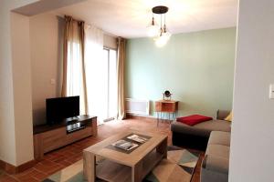 a living room with a couch and a table at L'Atlantique Appartement en front de mer in Jard-sur-Mer