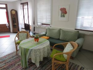 a living room with a table and a couch at Im Alten Kaufhaus in Rhodt unter Rietburg
