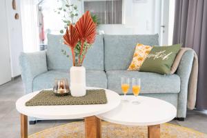 - un salon avec un canapé et une table avec deux verres dans l'établissement Residenz - Waldspaziergang - Terrasse - Sauna - Parkplatz, à Bad Zwischenahn 28 autres photos