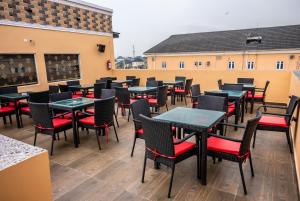 a row of tables and chairs on a patio at CHILLERS HOTEL AND SUITES in Aiyetoto-Asogun