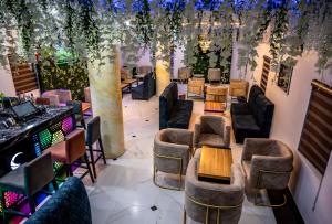 a restaurant with couches and tables and plants at CHILLERS HOTEL AND SUITES in Aiyetoto-Asogun