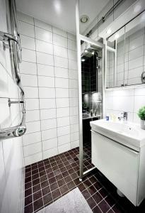 Baño blanco con lavabo y espejo en Luxury Apartment In City Centre, en Gotemburgo