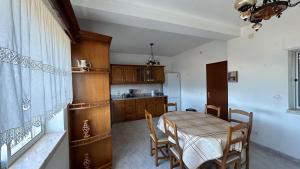 a kitchen with a table and chairs in a room at Casa da Tília in Vale Vazão