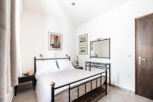 a bedroom with a bed and a mirror on the wall at Aegean Moments in Glinado Naxos