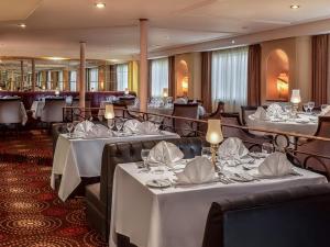 a restaurant with tables with white tablecloths at Steigenberger Regency Nile Cruise - Every Saturday from Luxor for 07 & 04 Nights - Every Wednesday From Aswan for 03 Nights in Luxor