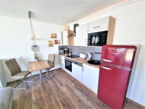 a kitchen with a red refrigerator and a table at Pferdeglück Pappenheimer in Oettingen in Bayern