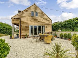 a small wooden house with a table and chairs at 3 bed in Ilminster 77987 in Cudworth