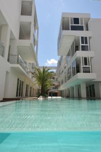 a swimming pool in the middle of two apartment buildings at Astoria Current in Boracay