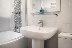 a white bathroom with a sink and a toilet at Well decorated 2 bed home in Handbridge, Chester in Hough Green +34 photos