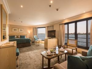 a hotel room with a living room with a view of the ocean at Steigenberger Regency Nile Cruise - Every Saturday from Luxor for 07 & 04 Nights - Every Wednesday From Aswan for 03 Nights in Luxor