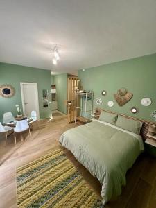 a bedroom with a large bed with a green wall at Tintarella da Monica in Lido di Ostia