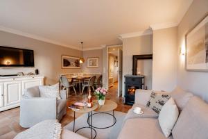a living room with a couch and a table at Ferienhaus Ekke Nekkepenn1 in Westerland (Sylt)