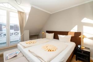 a bedroom with a large bed with two pillows on it at Ferienhaus Ekke Nekkepenn1 in Westerland (Sylt)