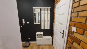 a bathroom with a mirror and a brick wall at Solanki Loft in Inowrocław