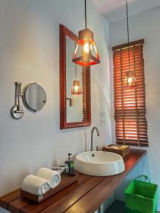 a bathroom with a sink and a mirror at Krabi Home Resort in Tab Kaek Beach