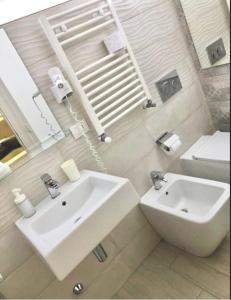 a bathroom with a white sink and a toilet at B&B Giulia in Taormina