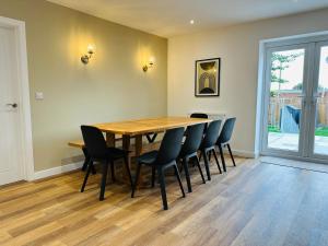a dining room with a wooden table and chairs at Bromholme Cottage Bacton - Sleeps 10, hot tub, close to beach in Bacton +15 photos