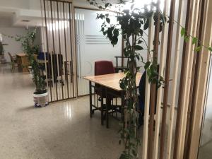 a table and chairs in a room with plants at Urban Hostel and Coworking in Arrecife