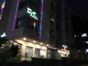 a building with neon signs on the side of it at night at IVY Studio in Pune