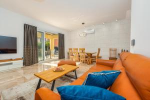 a living room with a couch and a table at Luxury Villa Agape Ellita in Vir