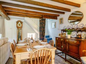 a dining room with a table and a clock at 3 Bed in Talybont-on-Usk BN351 in Talybont