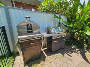 an outdoor grill with a stove and a grill at Gateway to Paradise in Westcourt