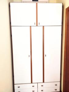 a large white dresser with four doors at Hotel Ambasciata in Cesenatico
