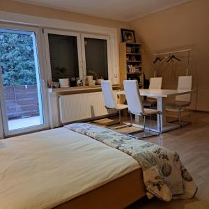 um quarto com uma cama, uma mesa e cadeiras em Messe Zimmer Hannover em Hanôver