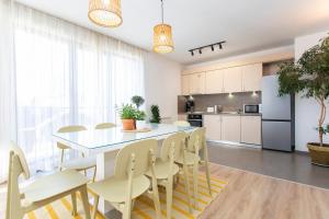 a kitchen and dining room with a table and chairs at Vitosha Downtown Apartments in Sofia