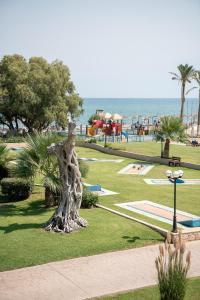 a statue of a giraffe standing in a park at Caldera Creta Paradise in Platanias