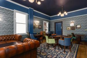 a bar with a leather couch and tables and chairs at The Pied Bull in Chester