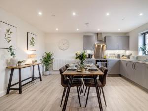 a kitchen and dining room with a table and chairs at 2 Bed in Usk 87949 in Trostrey