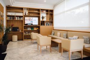 a waiting room with a couch and chairs at Comitas Floramar in Cala Galdana