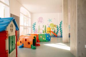 a childrens room with a play room with a play set at Comitas Floramar in Cala Galdana